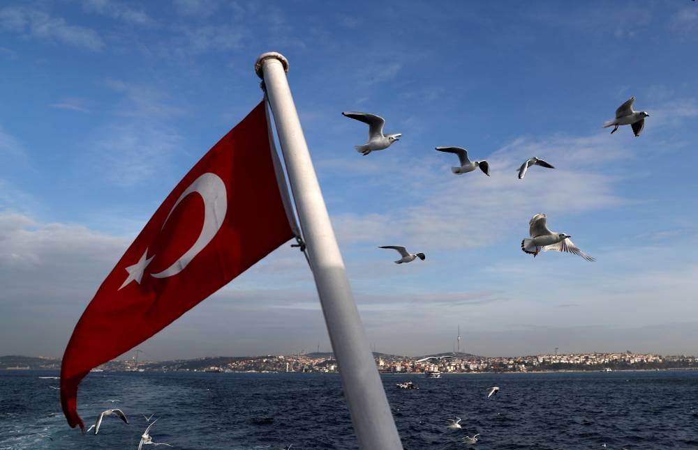 A Turkish flag flutters on a passenger ferry with the Bosphorus in the background in Istanbul. Gross domestic product expanded 1.6% on a quarterly basis, up from a revised 0.7% in the preceding three-month period when adjusted for seasonality and working days, Turkey’s statistics office said on Monday.