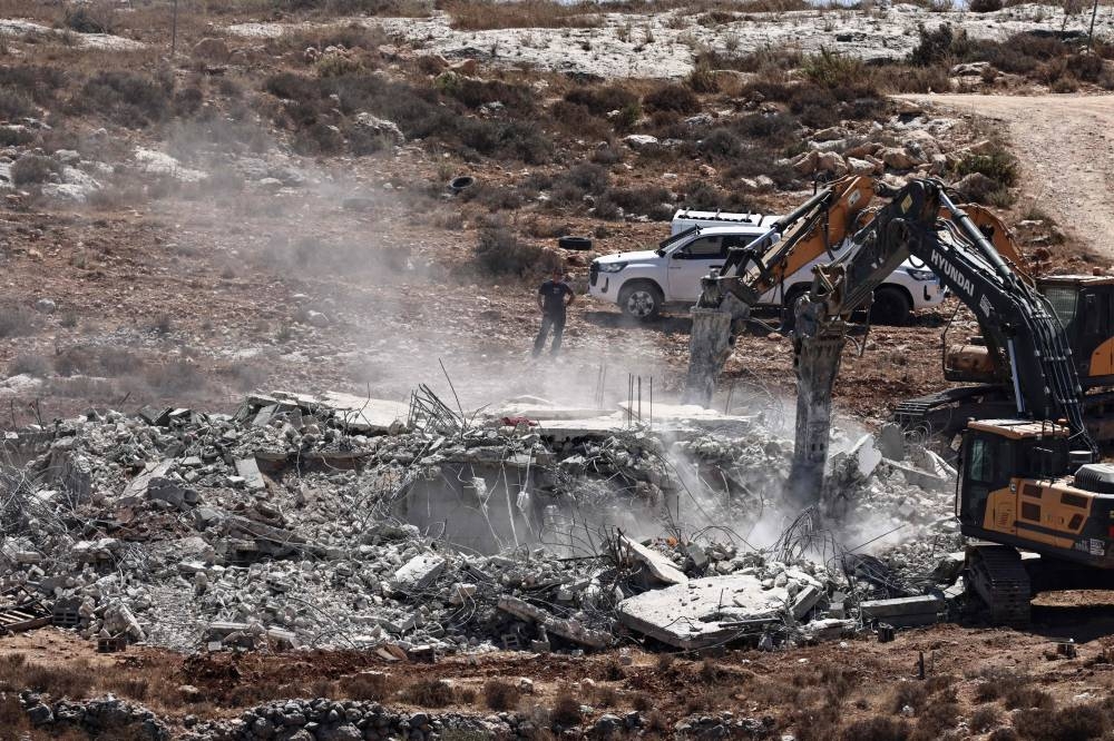 Israeli military bulldozers demolish a Palestinian-owned house in Shuqba village, west of Ramallah, in the occupied West Bank, on Monday. AFP