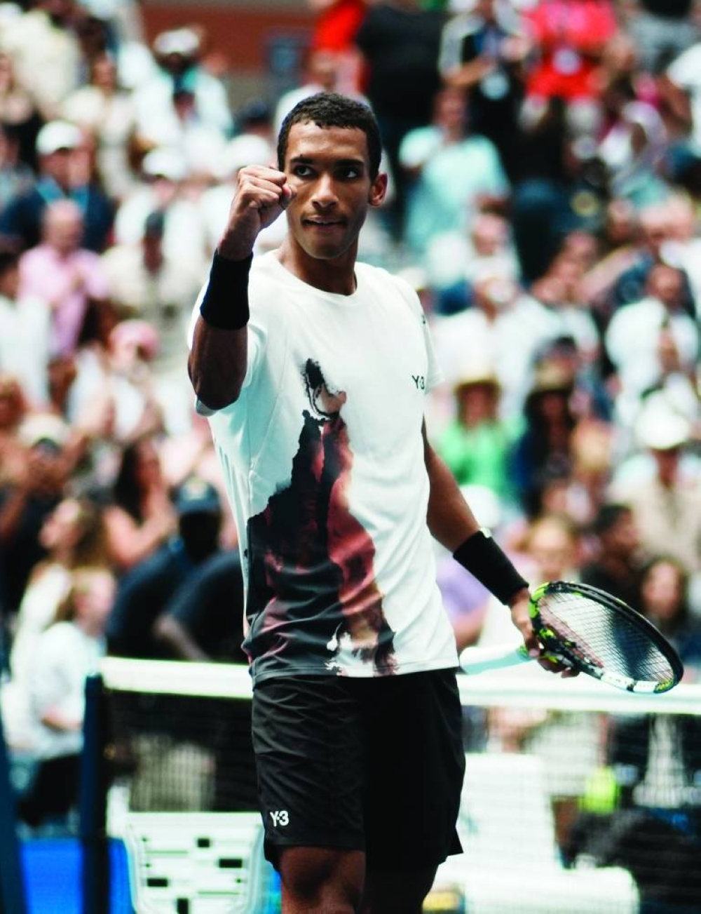 Canada’s Felix Auger-Aliassime celebrates winning his round of 16 match against Russia’s Andrey Rublev at the US Open in Flushing Meadows, New York, Monday. (Reuters)