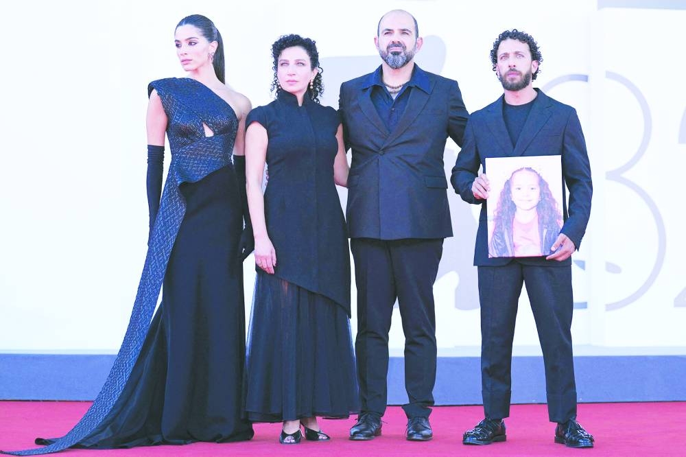 From left: Actress Saja Kilani, actress Clara Khoury, Israelian actor Amer Hlehel and actor Motaz Malhees, pose with a portrait of late Palestinian girl Hind Rajab, during the red carpet for the movie "The Voice of Hind Rajab" presented in competition at the 82nd International Venice Film Festival, at Venice Lido on September 3, 2025. (/ AFP)