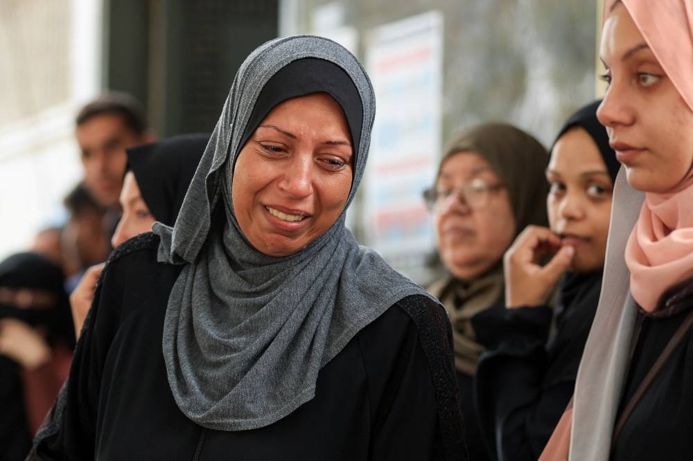 A mourner reacts during the funeral of Palestinians who were killed by Israeli fire while trying to receive aid on Wednesday and others who were killed in overnight strikes, according to medics, at Al-Shifa Hospital in Gaza City, September 4, 2025. REUTERS
