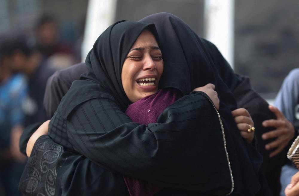 Mourners embrace during the funeral of Palestinians killed in overnight Israeli strikes, according to medics, at Al-Shifa Hospital in Gaza City, September 5, 2025. REUTERS