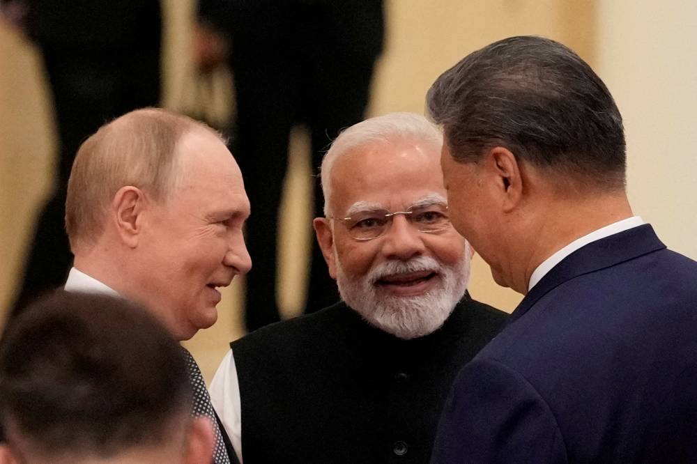 Indian Prime Minister Narendra Modi talks with Russian President Vladimir Putin and Chinese President Xi Jinping ahead of the Shanghai Co-operation Organisation Summit 2025 at the Meijiang Convention and Exhibition Centre in Tianjin, China, on September 1. The three nuclear powers collectively hold a third of the world’s population, vast natural resources and world-beating manufacturing power. Today, they account for roughly a quarter of global gross domestic product, up from about 5% at the turn of the century, and China has made steady strides in coming closer to catching up to the most cutting-edge US technology.