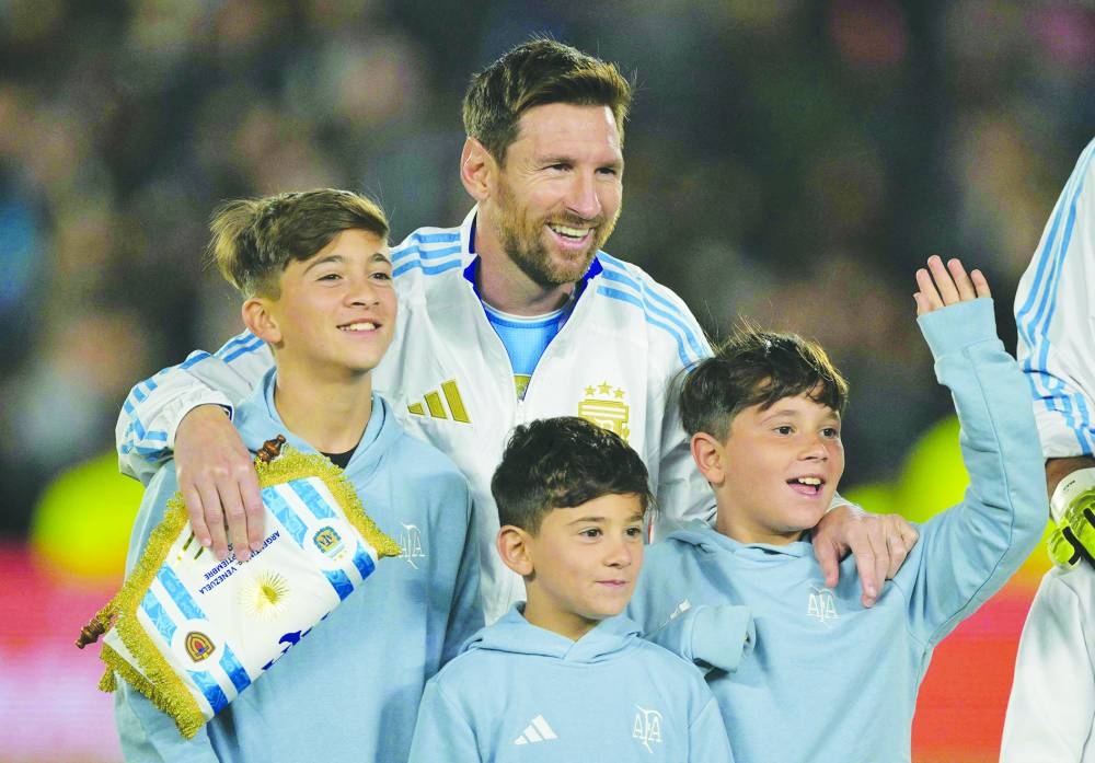 Argentina's forward #10 Lionel Messi hugs his sons ahead of the 2026 FIFA World Cup South American qualifiers football match between Argentina and Venezuela at the Mas Monumental stadium in Buenos Aires on September 4, 2025. (AFP)