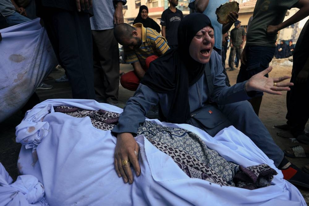 A mourner reacts during the funeral of Palestinians killed by Israeli fire while trying to receive aid on Friday, and others killed in overnight strikes, according to medics, at Al-Shifa Hospital in Gaza City, September 6, 2025. REUTERS