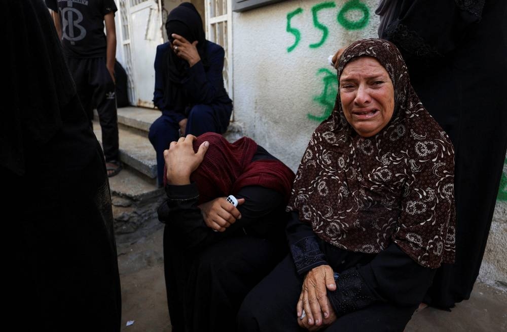 Mourners react during the funeral of Palestinians killed by Israeli fire while trying to receive aid on Friday, and others killed in overnight strikes, according to medics, at Al-Shifa Hospital in Gaza City, September 6, 2025. REUTERS