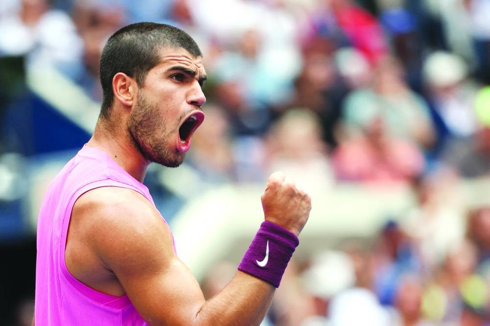 Carlos Alcaraz of Spain celebrates winning the second set tie break against Novak Djokovic of Serbia during their Men's Semifinal match on Day Thirteen of the 2025 US Open at USTA Billie Jean King National Tennis Center on September 5, 2025, in the Flushing neighborhood of the Queens borough of New York City.  (AFP)