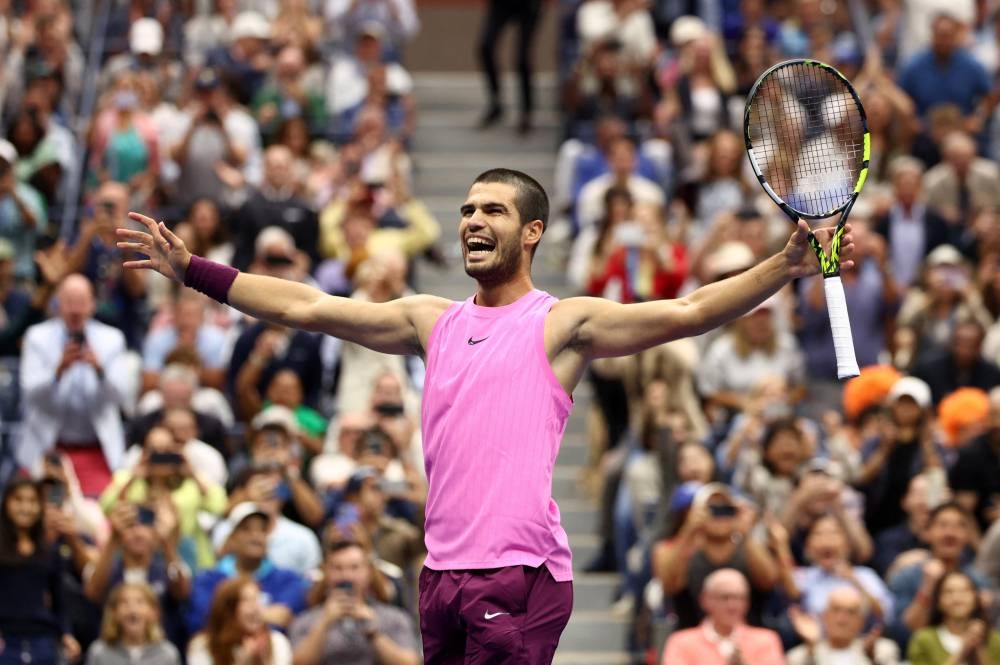 Spain's Carlos Alcaraz celebrates winning the men's singles final against Italy's Jannik Sinner. REUTERS
