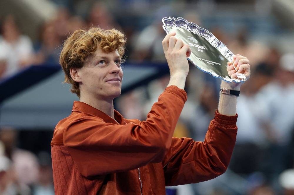 Italy's Jannik Sinner holds the runner up trophy after losing the men's singles final to Spain's Carlos Alcaraz. REUTERS