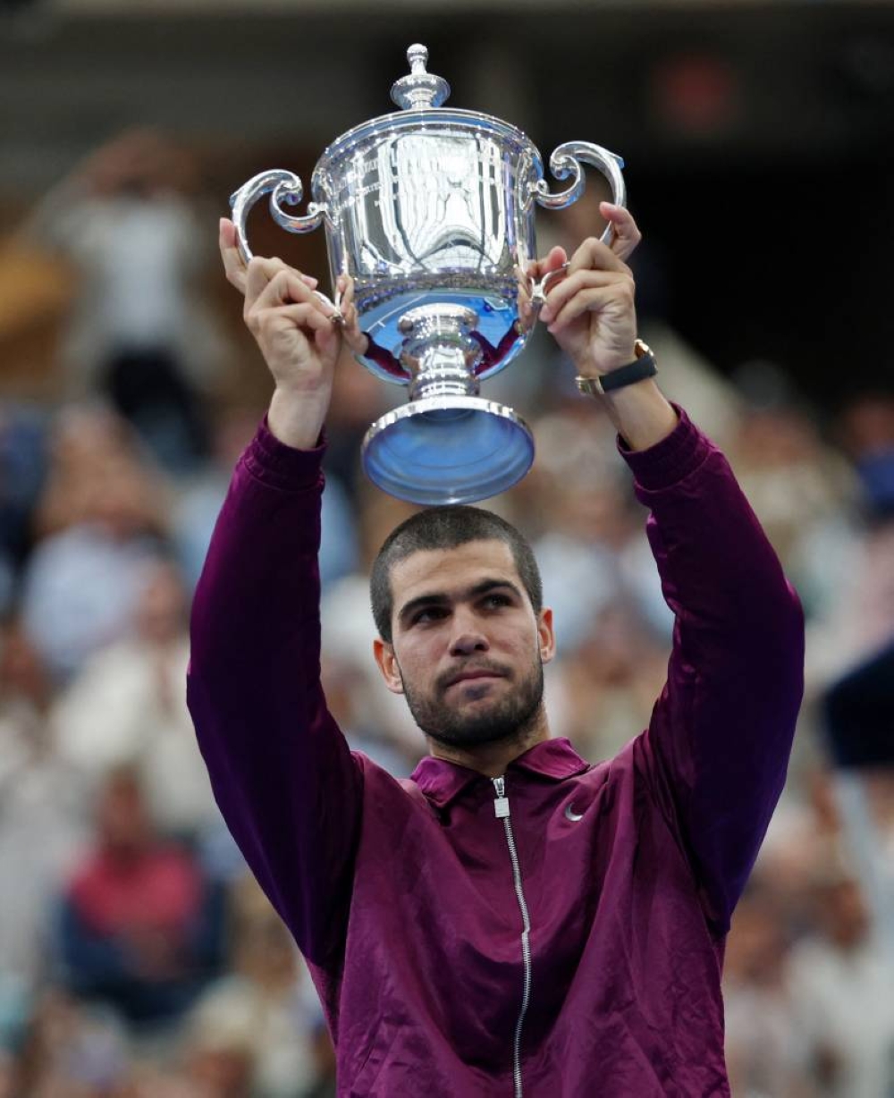 Spain's Carlos Alcaraz celebrates with the trophy after winning the men's singles final. REUTERS