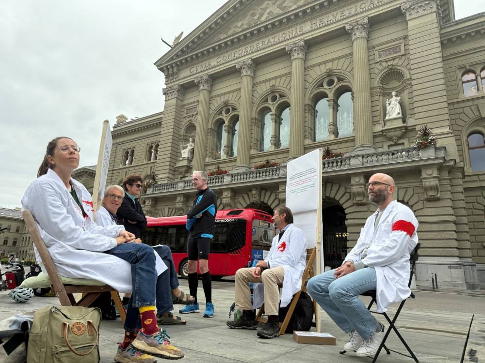 Doctors Michele Ghielmini, Brenno Balestra, Alessandra Guaita and Marco Franzi sit outside the Swiss Parliament building (Bundeshaus) at the start of their hunger strike over Gaza, calling on their government to apply targeted sanctions on Israel over its alleged violations of international law and to recognise a Palestinian state, in Bern, Switzerland, September 8, 2025.  REUTERS