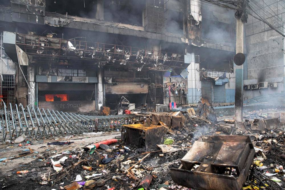 Smoke billows from a burning supermarket building of Nepal's renowned retail chain Bhat-Bhateni, a day after it was set ablaze by protesters in Kathmandu on Wednesday. AFP