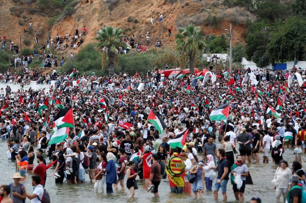 People gather, as they await the departure of the Global Sumud flotilla at the port of Sidi Bou Said, bound to leave for Gaza from Tunisia, along with other Tunisian boats, in a major act of solidarity with the Palestinian people against the Israeli blockade, Sidi Bou Said, Tunisia, Tunisia, on Wednesday. REUTERS