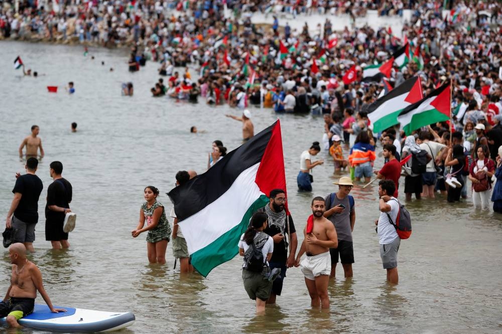 People gather as they await the departure of the Gaza-bound Global Sumud flotilla in solidarity with the Palestinian people against the Israeli blockade, in Sidi Bou Said, Tunisia, Tunisia, on Wednesday. REUTERS