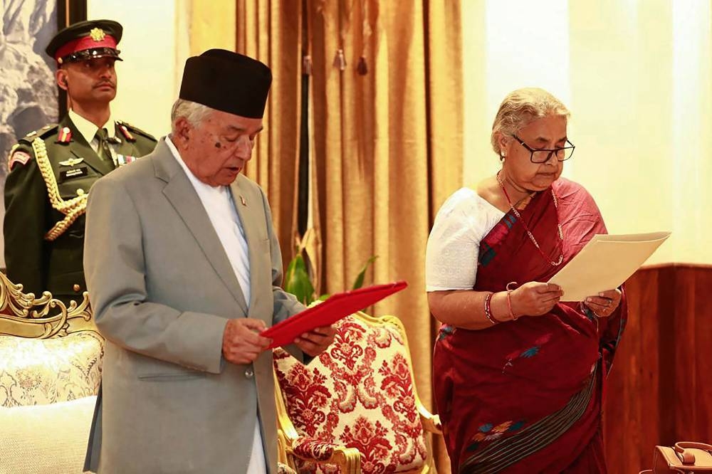 Nepal's President Ram Chandra Paudel (L) administers the oath to the country's newly appointed Prime Minister Sushila Karki during her swearing-in-ceremony at the President House in Kathmandu on Friday. AFP