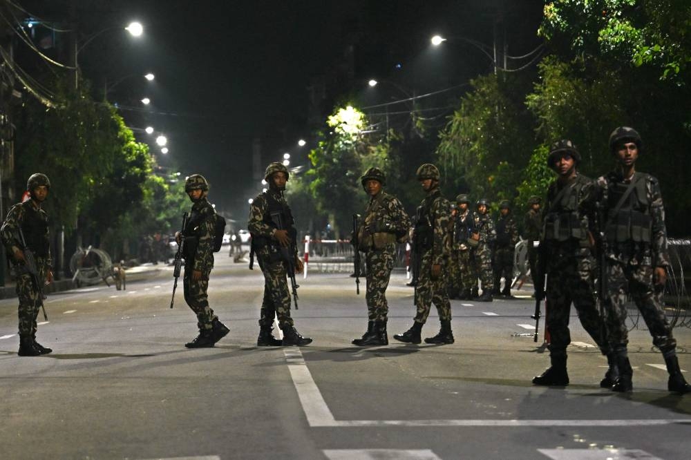 Nepal's army soldiers stand guard along a street in front of the President House during the swearing-in-ceremony of country's new prime minister Sushila Karki, in Kathmandu on Friday. AFP