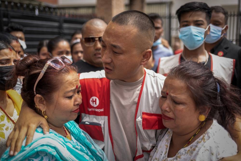 Sudan Gurung, 36, founder of Hami Nepal, cries after meeting the family members of the victims, who died following last week's deadly anti-corruption protests, outside a morgue at a hospital, in Kathmandu, Nepal, on Sunday. REUTERS