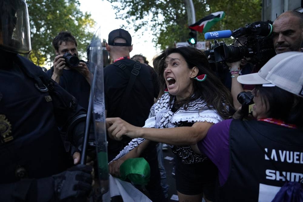 Pro Palestine protesters clash with police during Vuelta a Espana Stage 21. REUTERS