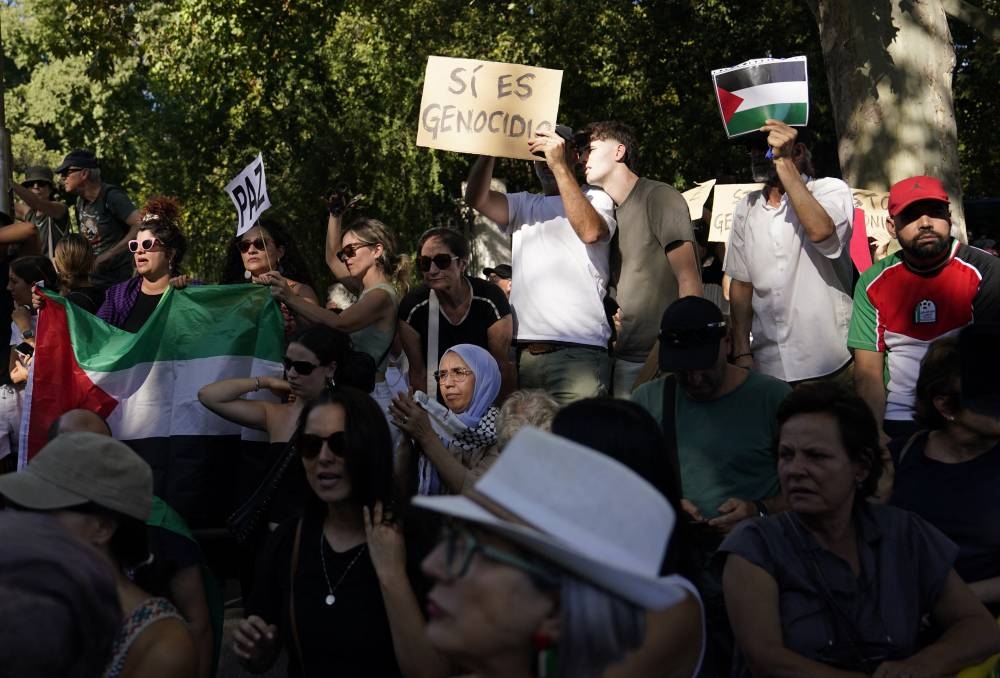 Pro Palestine protesters with flags during Vuelta a Espana Stage 21. REUTERS