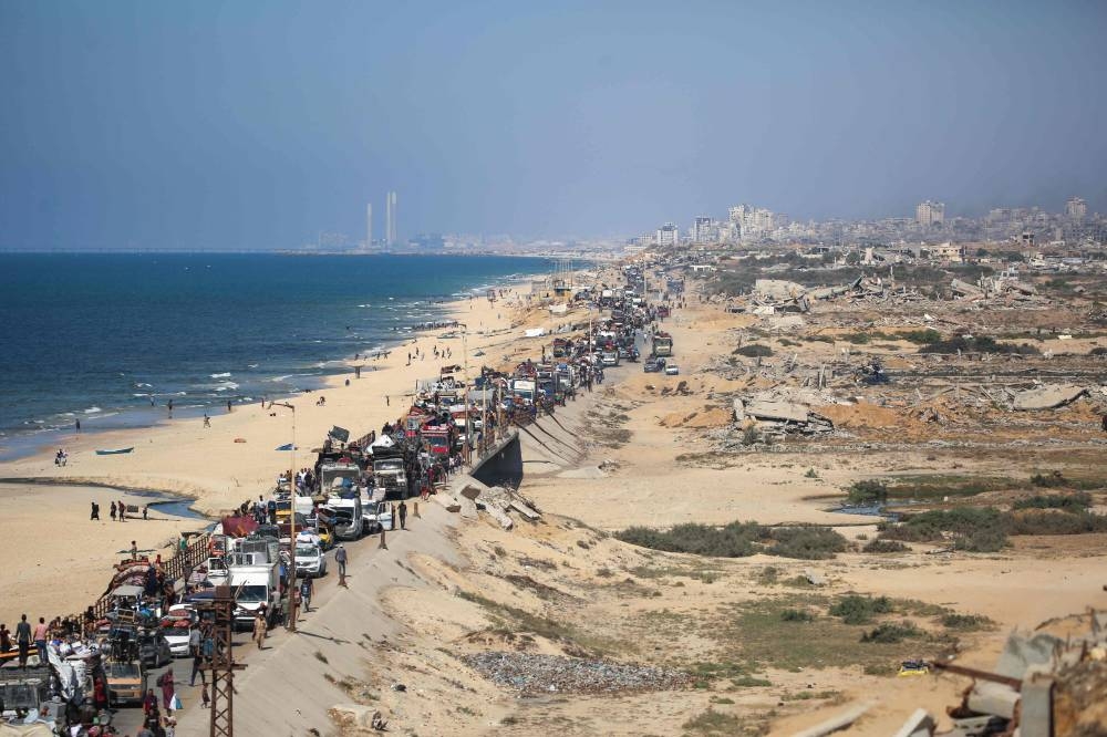 Displaced Palestinians move with their belongings southwards on a road in the Nuseirat refugee camp area in the central Gaza Strip following renewed Israeli evacuation orders for Gaza City, on Sunday. AFP