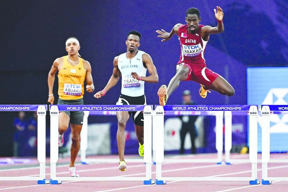 Qatar's athlete Ismail Doudai Abakar (R) competes in the men's 400m hurdles heats during the World Athletics Championships in Tokyo, on Monday. AFP