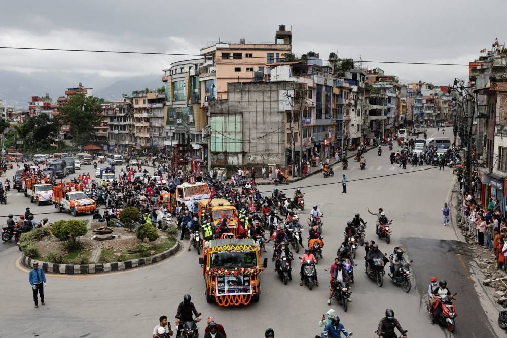 People take part in a tribute rally with the coffins carrying the bodies of people, who died in last week's anti-corruption protests that toppled the government, in Kathmandu, Nepal, on Tuesday. REUTERS