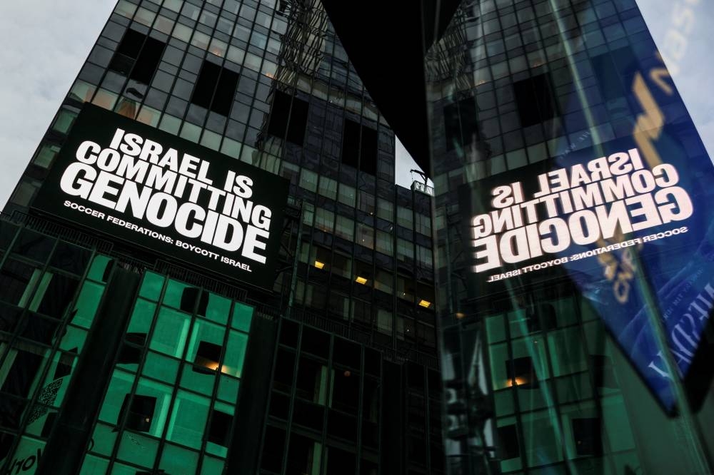 A billboard in Times Square displays the message "Israel is committing genocide" as part of the campaign by Game Over Israel calling for a boycott of Israel by national soccer federations over the war in Gaza, in New York City, U.S., September 16, 2025. Israel is fighting a genocide case at the International Court of Justice in The Hague and has rejected such accusations, citing its right to self-defense following the deadly October 7, 2023, Hamas attack.  REUTERS/Jeenah Moon