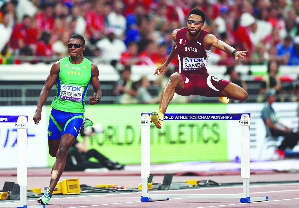 Brazil's Francisco Guilherme Dos Reis Viana and Qatar's Abderrahman Samba in action during their heat. REUTERS