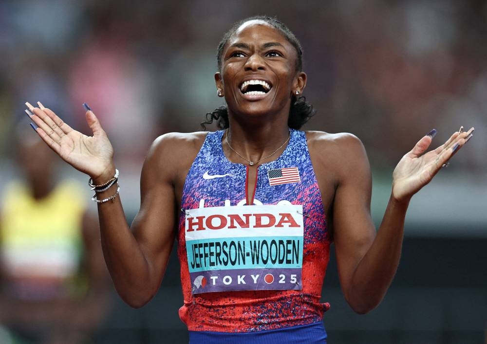 Melissa Jefferson-Wooden of the US celebrates after winning the gold medal. REUTERS