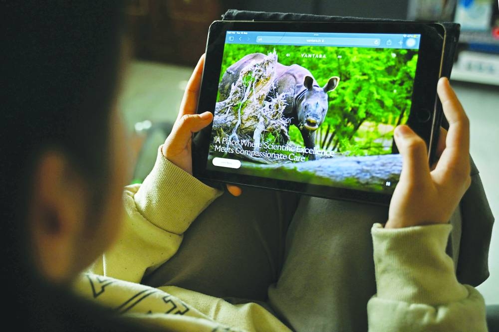 
In this photo illustration taken on Sept 16, 2025 shows a girl browsing through the Vantara’s website on her iPad, in Bengaluru. 