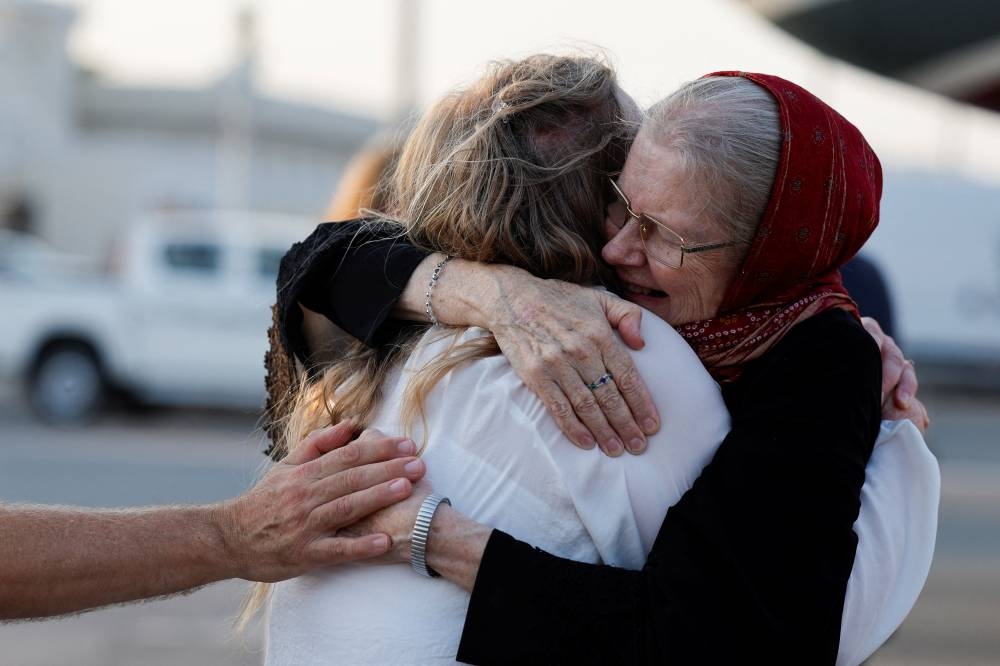Barbie Reynolds, who was released from Taliban detention in Afghanistan, is greeted after disembarking from a plane, in Doha, Qatar. REUTERS