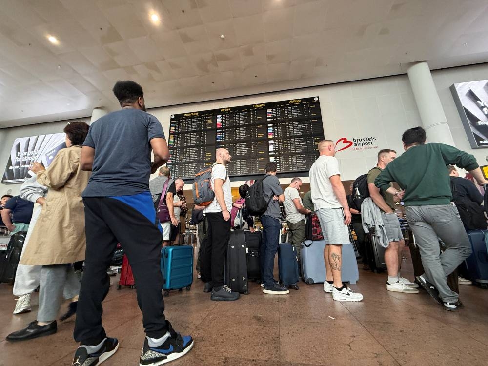 Travellers wait in queues at Brussels airport, after a cyberattack at a service provider for check-in and boarding systems disrupted operations at several major European airports, in Zaventem near Brussels, Belgium September 20, 2025. REUTERS