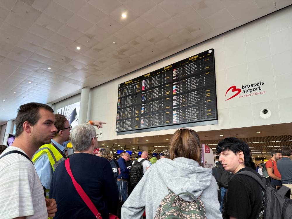 Travellers wait at Brussels airport, after a cyberattack at a service provider for check-in and boarding systems disrupted operations at several major European airports, in Zaventem near Brussels, Belgium September 20, 2025. REUTERS