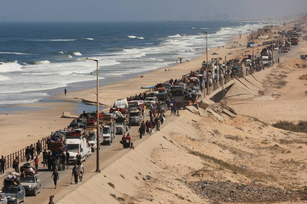 Displaced Palestinians, fleeing northern Gaza due to an Israeli military operation, move southwards after Israeli forces ordered residents of Gaza City to evacuate to the south, in the central Gaza Strip, September 20, 2025. REUTERS