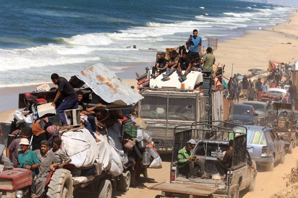 Displaced Palestinians, fleeing northern Gaza due to an Israeli military operation, move southwards after Israeli forces ordered residents of Gaza City to evacuate to the south, in the central Gaza Strip, on Saturday. REUTERS