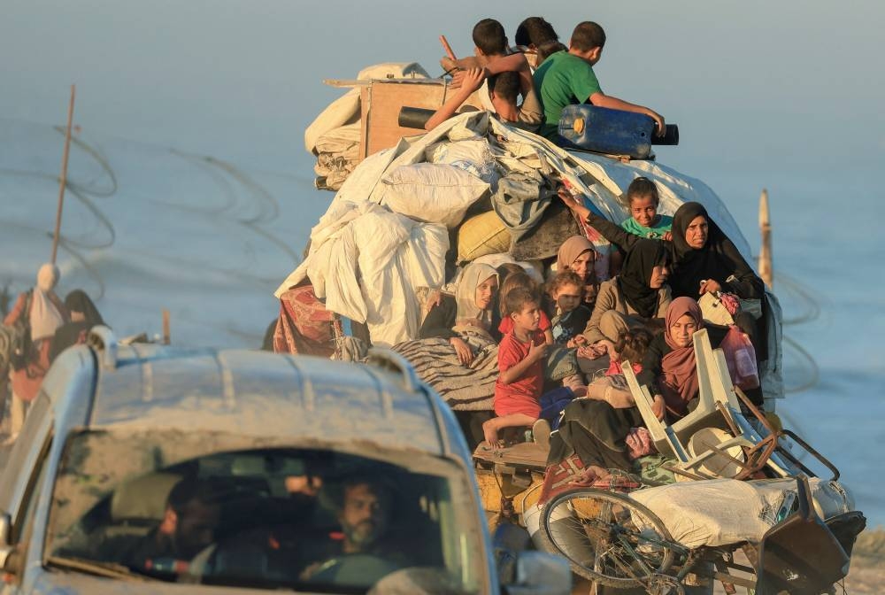 Displaced Palestinians, fleeing northern Gaza due to an Israeli military operation, move southwards after Israeli forces ordered residents of Gaza City to evacuate to the south, in the central Gaza Strip, on Saturday. REUTERS