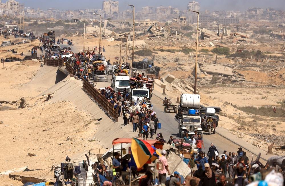 Displaced Palestinians, fleeing northern Gaza due to an Israeli military operation, move southwards after Israeli forces ordered residents of Gaza City to evacuate to the south, in the central Gaza Strip, on Saturday. REUTERS