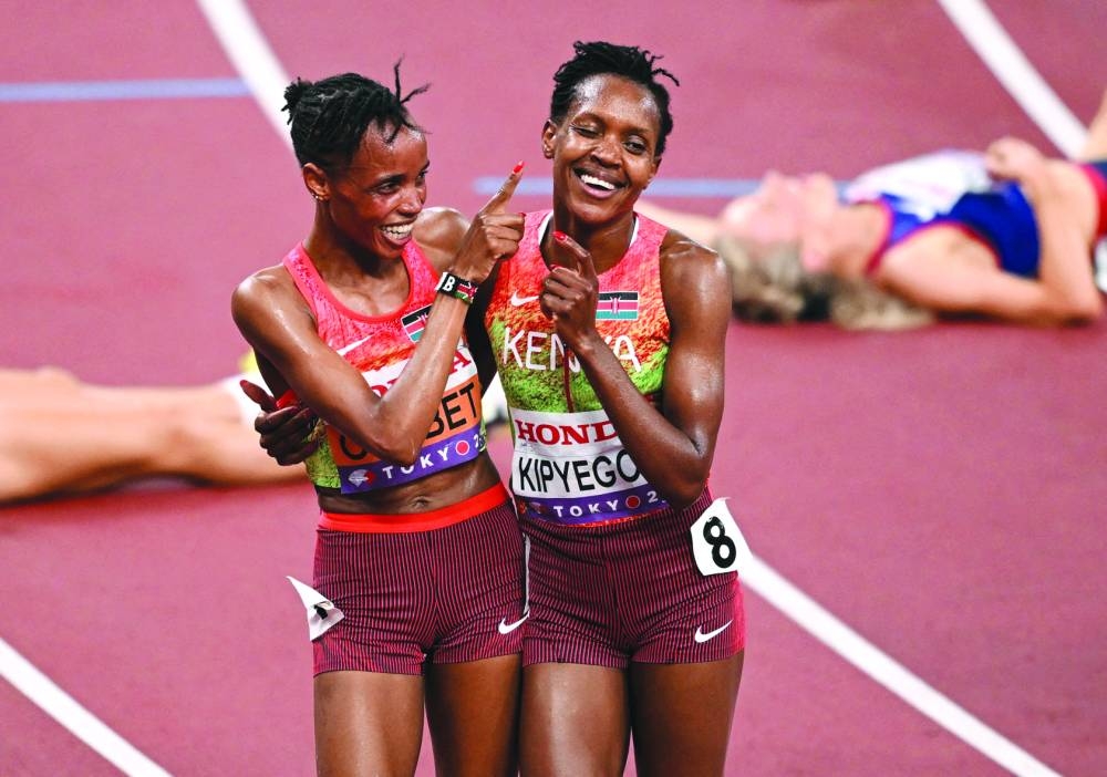 Gold medallist Kenya's Beatrice Chebet celebrates with silver medallist Kenya's Faith Kipyegon after winning the final during the World Athletics Championships in Tokyo on Saturday. REUTERS