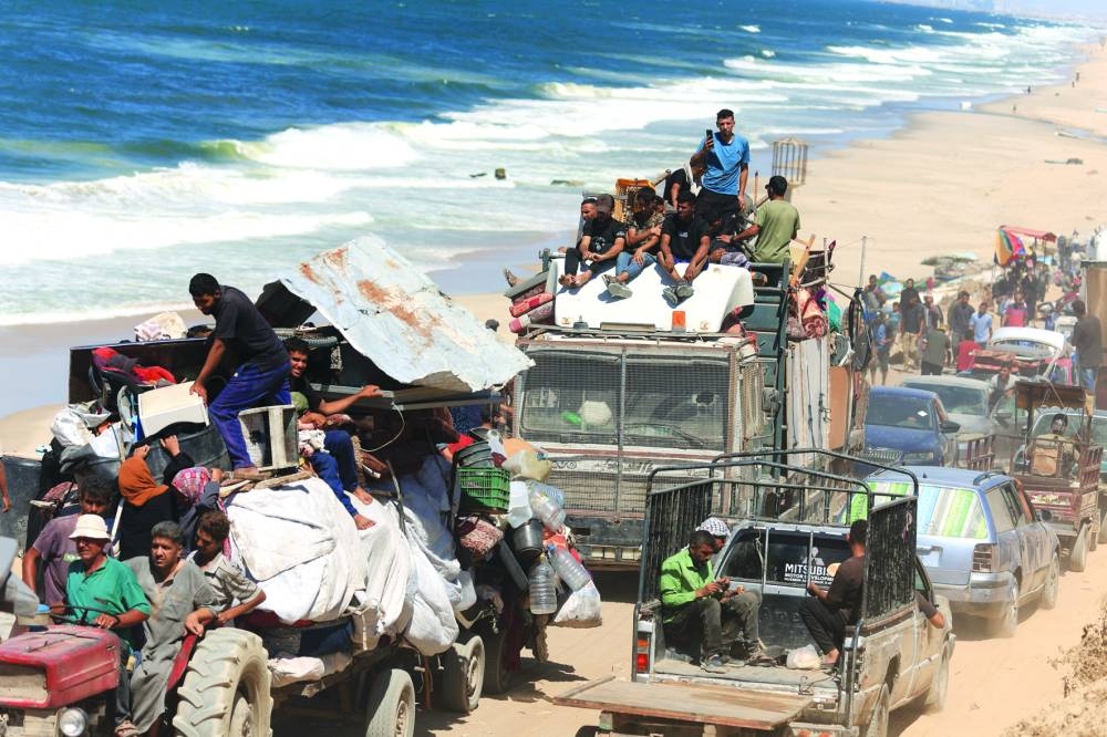 Displaced Palestinians, fleeing northern Gaza due to an Israeli military operation, move southwards, in the central Gaza Strip, Saturday.
