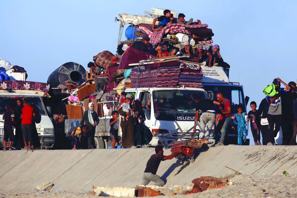 Displaced Palestinians, fleeing northern Gaza due to an Israeli military operation, move southwards, in the central Gaza Strip, Saturday.