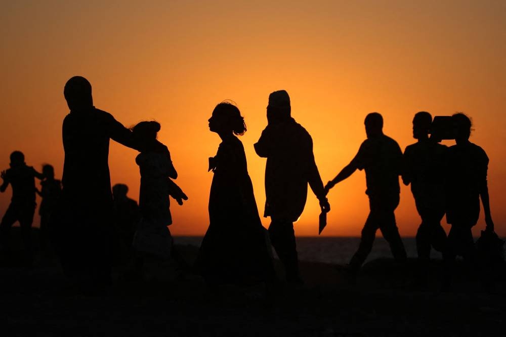 Displaced Palestinians move with their belonging's southwards on a road in the Nuseirat refugee camp area in the central Gaza Strip, as Israel presses its ground offensive to capture Gaza City. AFP