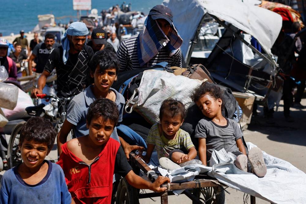 Displaced Palestinian children, part of many fleeing northern Gaza due to an Israeli military operation, move southward, after Israeli forces ordered residents of Gaza City to evacuate to the south, in the central Gaza Strip, on Sunday. REUTERS