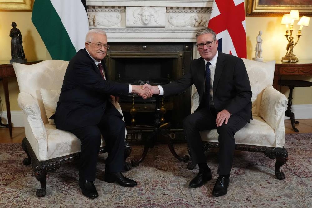Britain's Prime Minister Keir Starmer (R) shakes hands with Palestinian president Mahmud Abbas (L) at the beginning of their meeting at 10 Downing Street in London on September 8, 2025. AFP