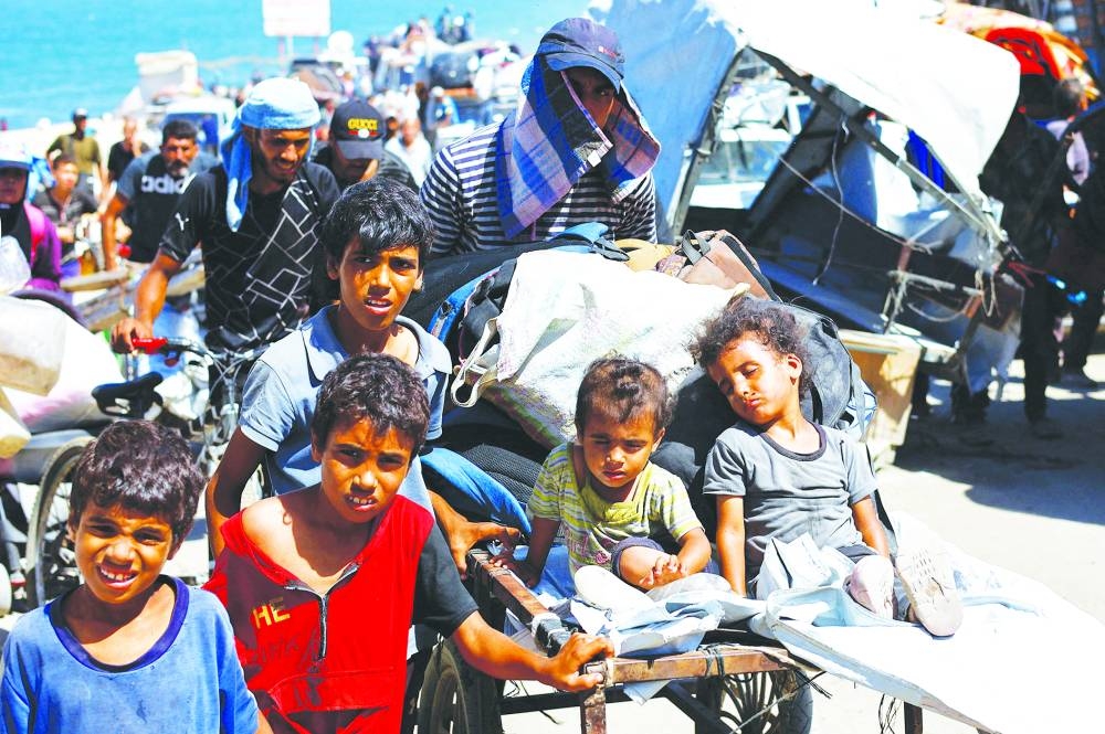 Displaced Palestinian children, part of many fleeing northern Gaza due to an Israeli military operation, move southward, after Israeli forces ordered residents of Gaza City to evacuate to the south, in the central Gaza Strip, Sunday.