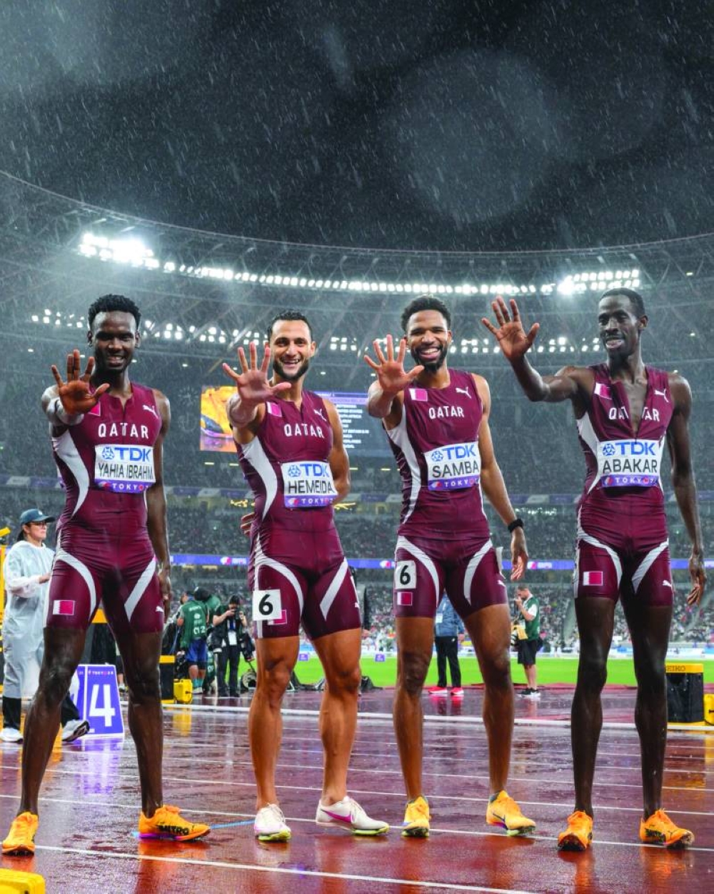 Members of Qatar’s 4x400m relay team celebrate after finishing fifth.