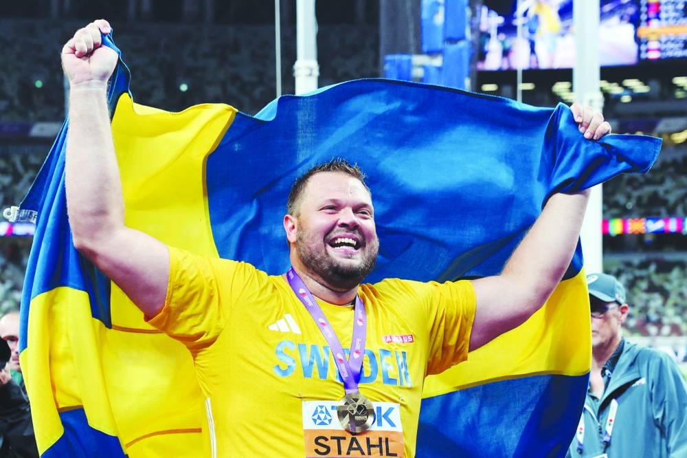Sweden's Daniel Stahl celebrates with his medal and national flag after winning gold. REUTERS