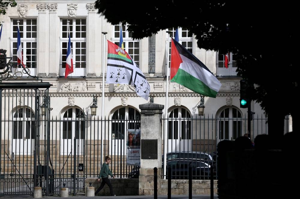 The Palestinian flag flies next to the flag of the city of Nantes in front of the town hall in Nantes, France, the day the French President is due to officially announce France's recognition of the Palestinian state at the UN General Assembly, on Monday. REUTERS