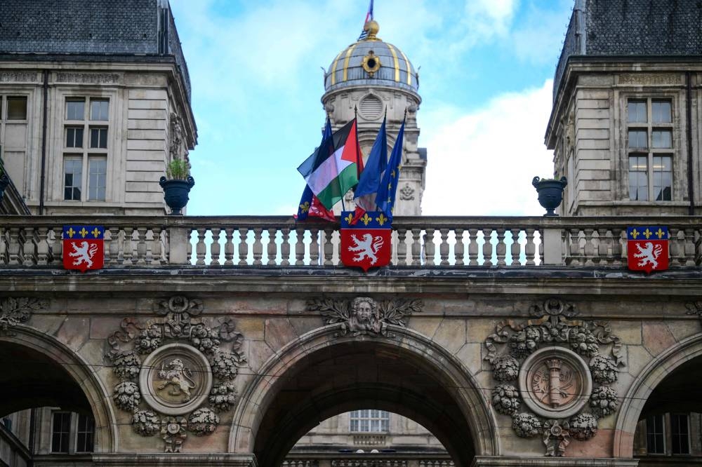 The Palestinian flag is placed along side the French Flag, the flag of Lyon, and the European Union flag, over the entrance of the Lyon City Hall, in eastern France, on the day France plans the recognition of a Palestinian State at the United Nations, on Monday. AFP