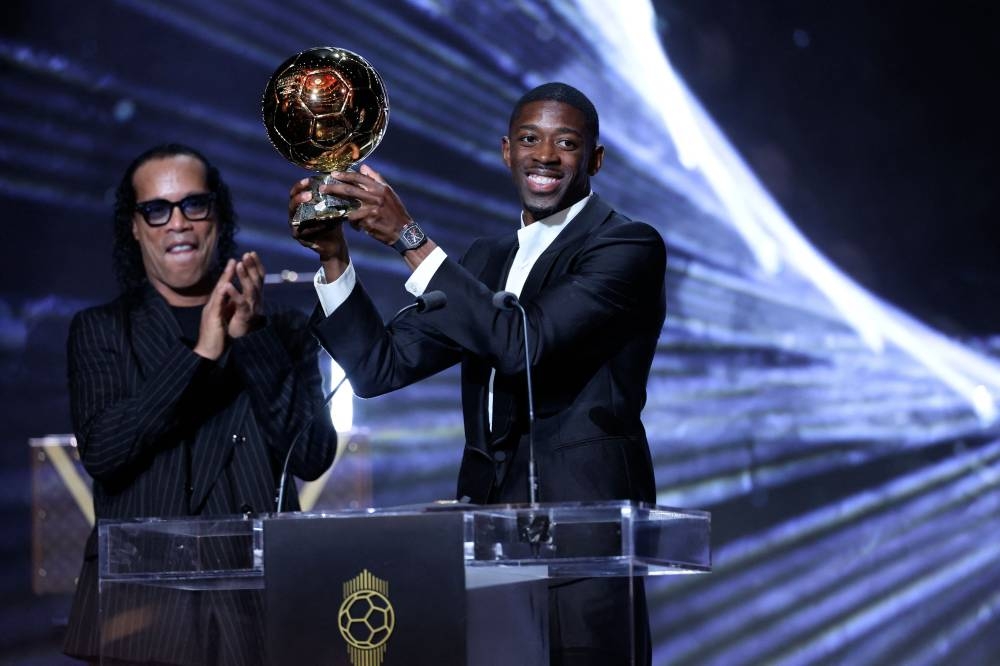 Paris Saint-Germain's French forward Ousmane Dembele receivesthe Ballon d'Or award from Brazilian former football player Ronaldinho (L) during the 2025 Ballon d'Or France Football award ceremony at the Theatre du Chatelet in Paris on Monday. AFP