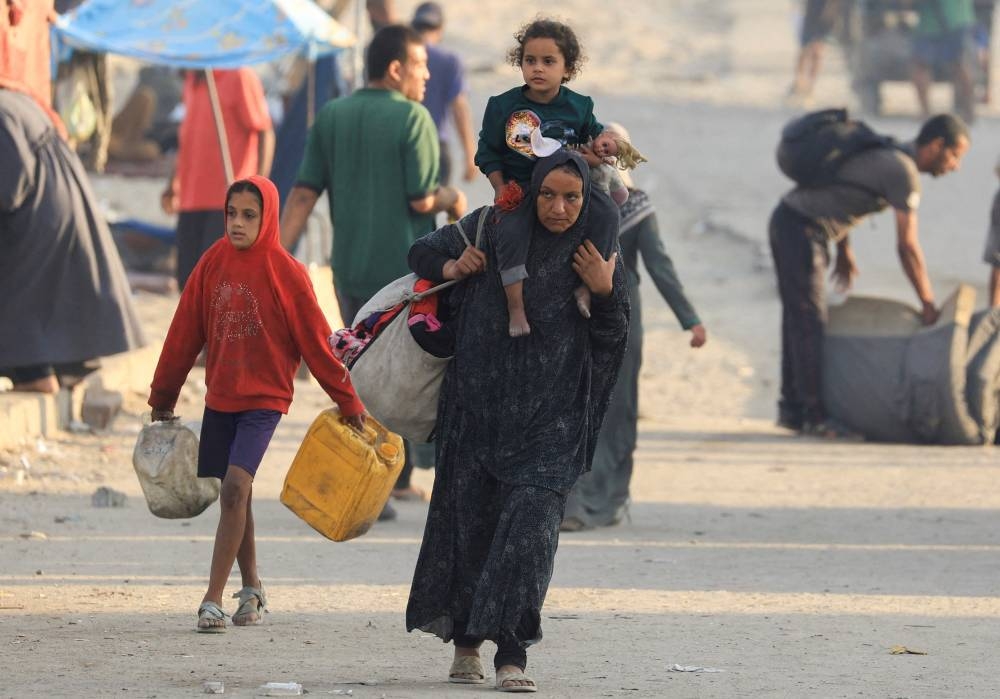Displaced Palestinians, fleeing northern Gaza due to an Israeli military operation, move southward after Israeli forces ordered residents of Gaza City to evacuate to the south, in the central Gaza Strip, on Wednesday. REUTERS
